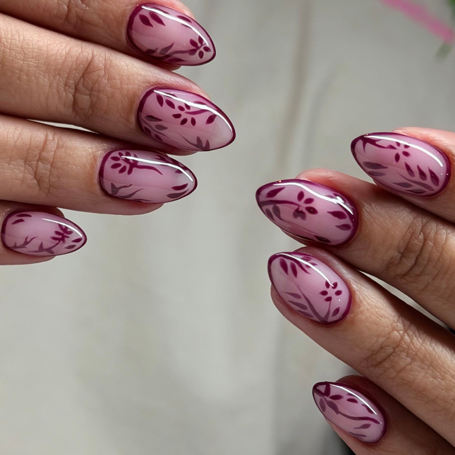 Mauve almond nails with hand-painted burgundy floral vines